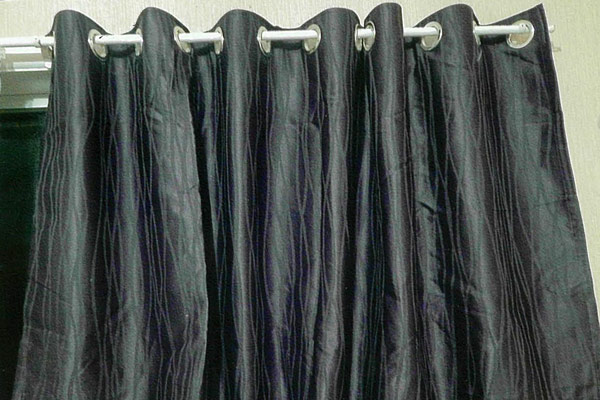 Finished eyelet curtains hanging from a rod